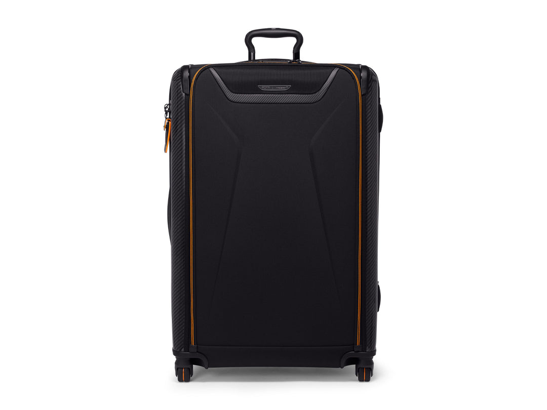 Front view of TUMI | McLaren Aero Extended Trip Packing Case with carbon fiber accents and orange trim.