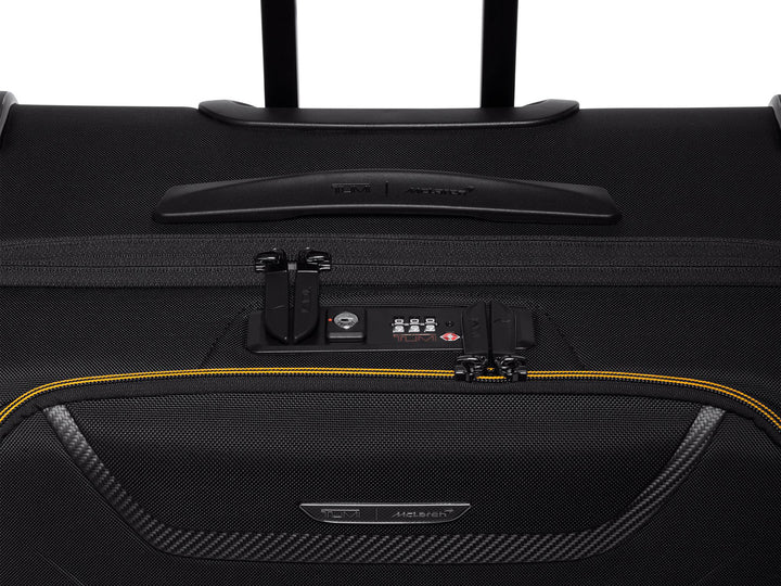 Close-up of the TUMI | McLaren Aero Extended Trip Packing Case's front pocket and carbon fiber detail.