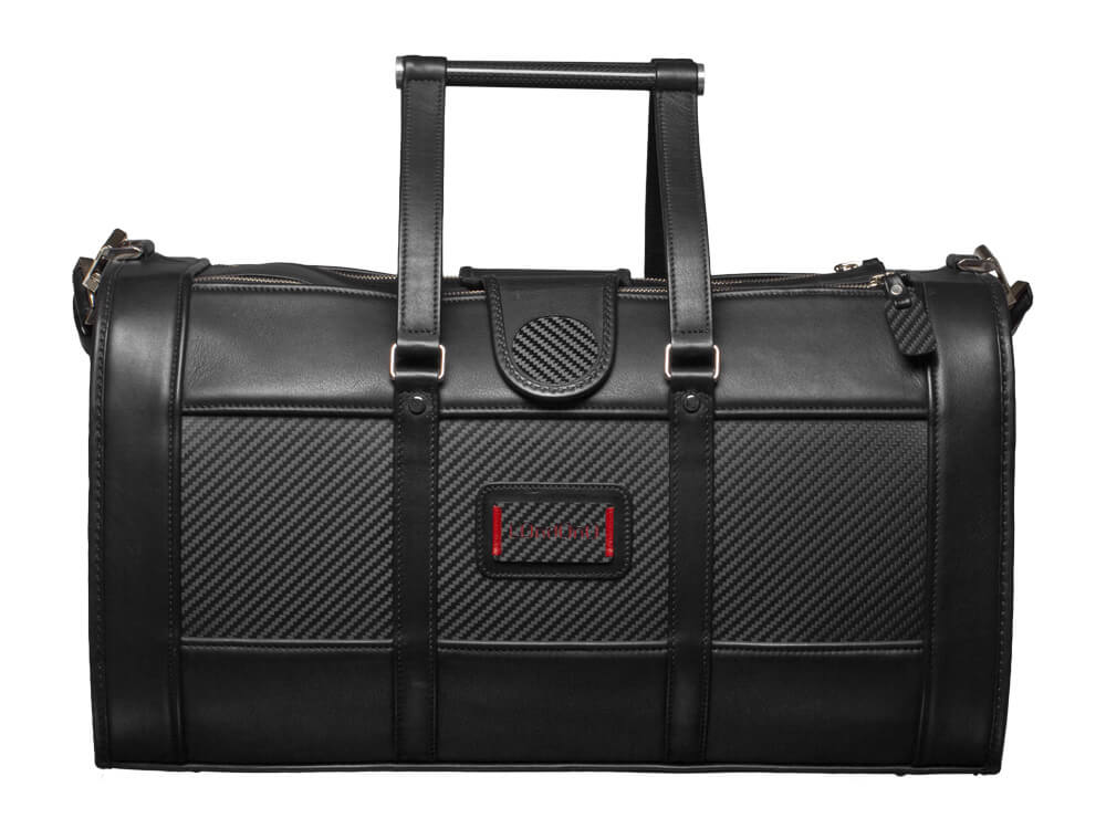 Elegant black leather weekend bag with carbon fiber accents and sturdy handles.