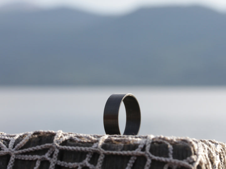 Bullet carbon fiber ring with water in background