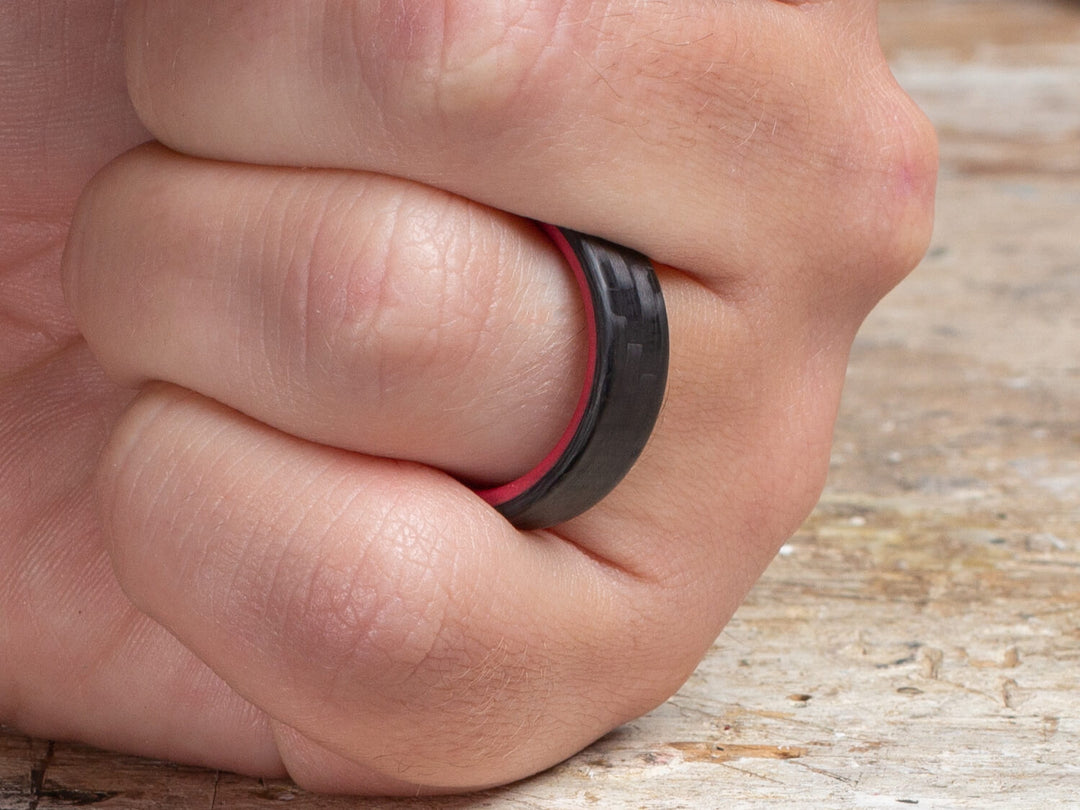 Red carbon fiber glow ring on hand