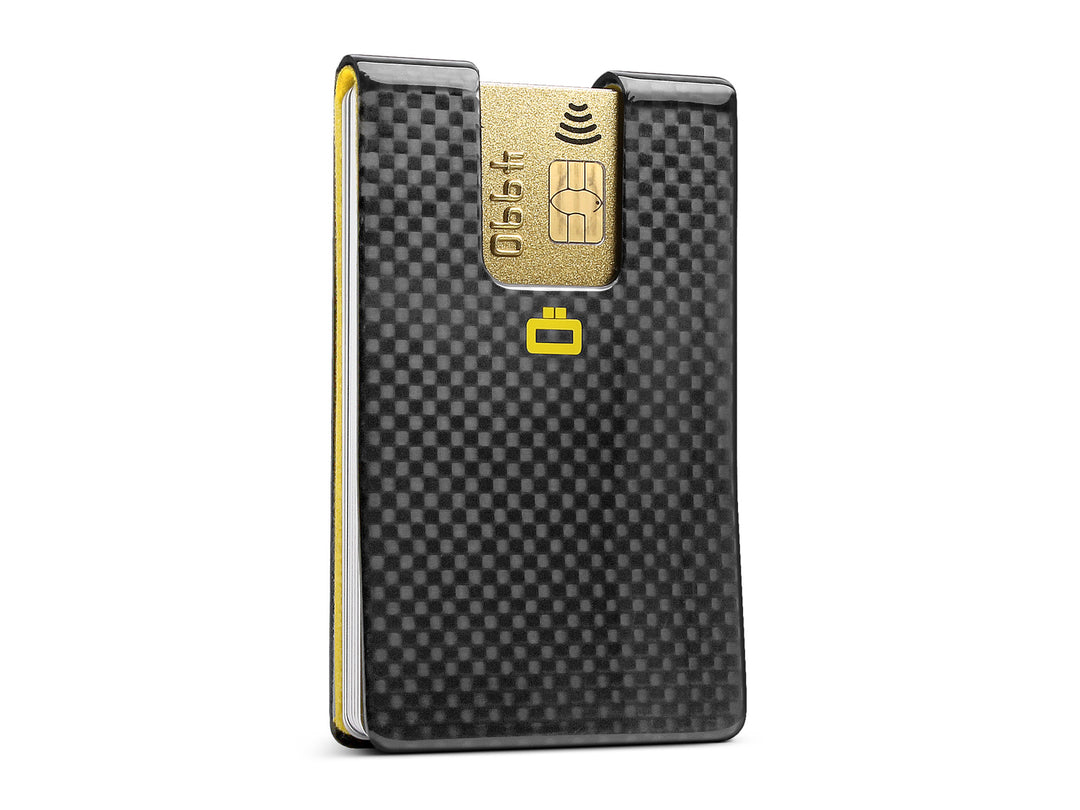 Ogon 3C Carbon Fiber RFID Blocking Card Clip with a gold credit card inserted, displaying its sleek design and texture.