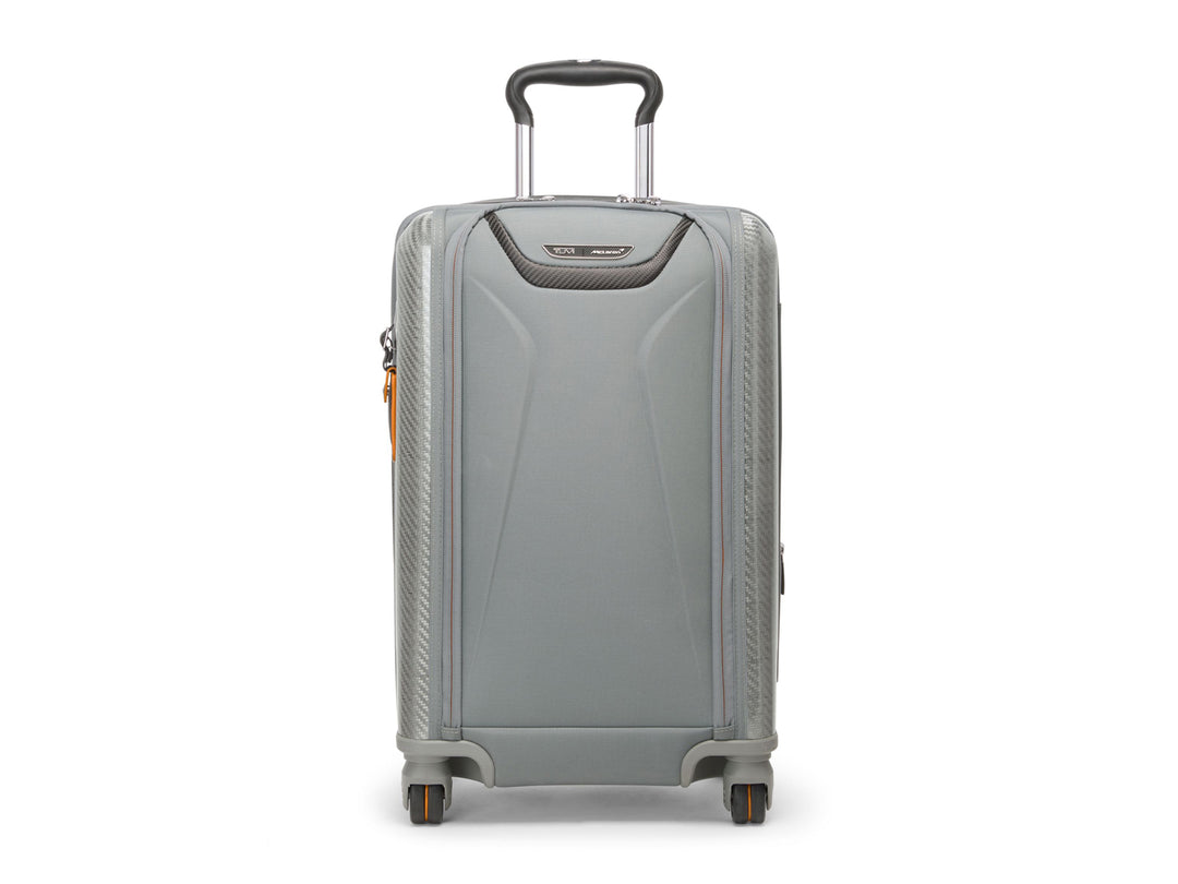 Front view of TUMI McLaren Aero carry-on in Super Grey showing carbon fiber accents and telescoping handle