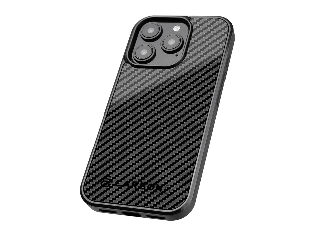 CarboFend iPhone 16 Pro Max case at an angle showing the 3K carbon fiber back panel texture and raised camera protection ring