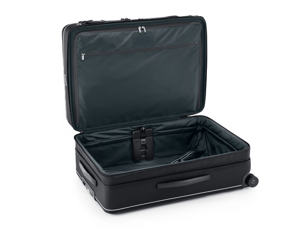 TUMI Arrivé luggage open showing front lid access with compression straps and organized interior compartments