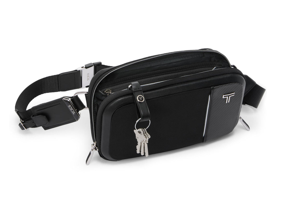 TUMI Arrivé Messina Compact Sling with carbon fiber panel and dual-access zippers on white background