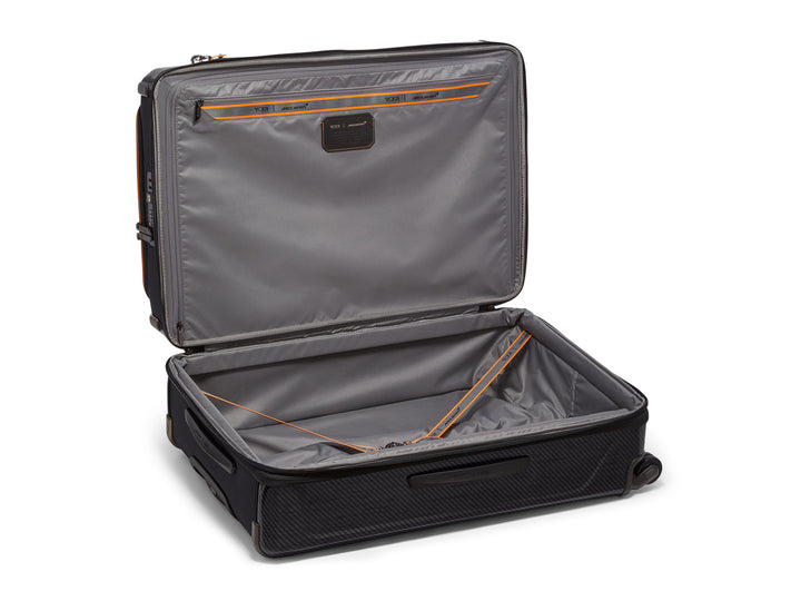Open TUMI | McLaren Aero Extended Trip Packing Case showing interior compartments and packing straps.
