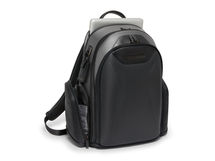 Angled view of TUMI x McLaren Paddock Backpack showing zippered laptop compartment.