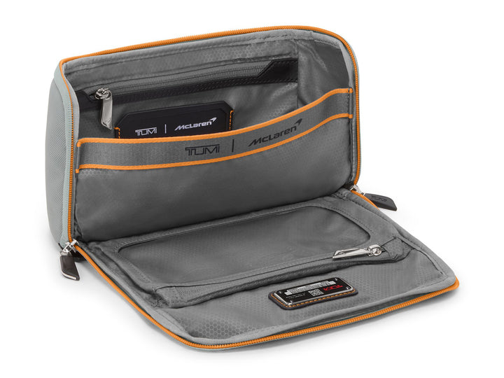 Interior view of Remex accessory kit showing organization pockets with Papaya orange trim and clear-window compartment