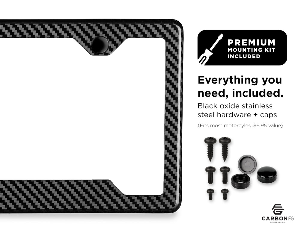 Carbon fiber license plate frame with included black oxide stainless steel hardware and caps, shown with premium mounting kit contents