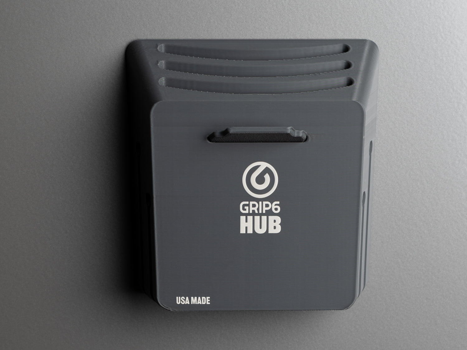 Close-up of the Grip6 Hub belt organizer wall-mounted, showcasing USA Made label and clean, minimalist design.