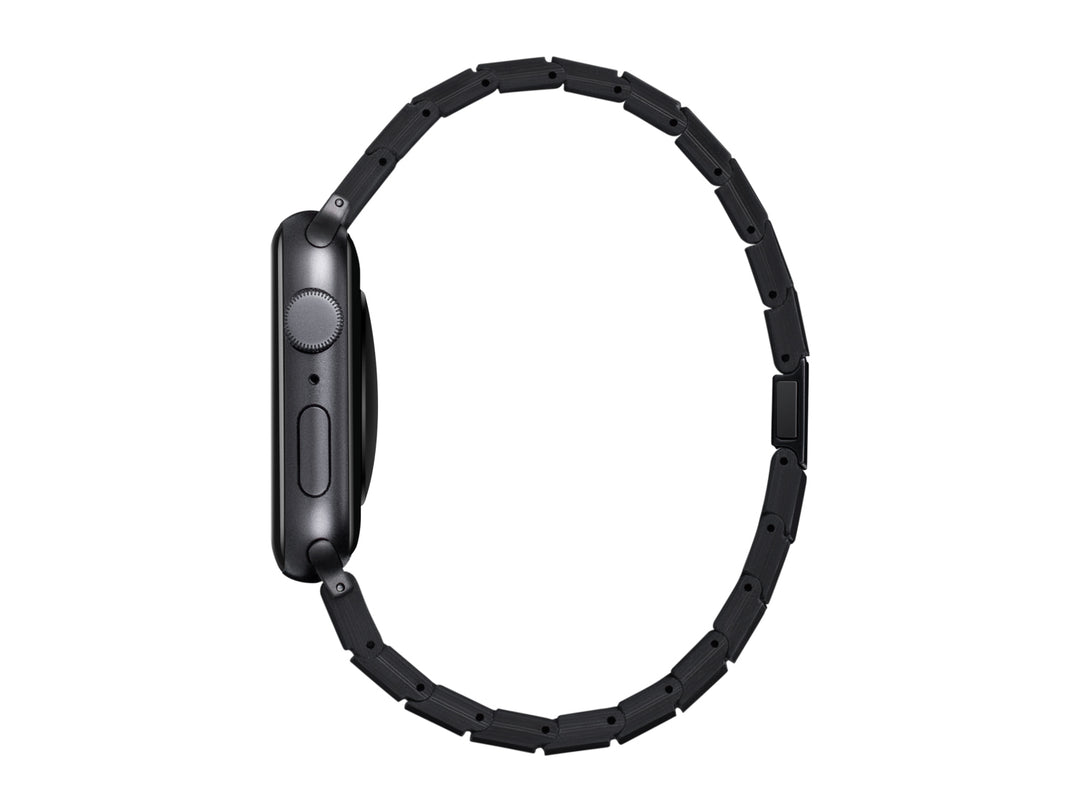 Side view of an Apple Watch with a carbon fiber band, emphasizing the slim profile and patented magnetic clasp.