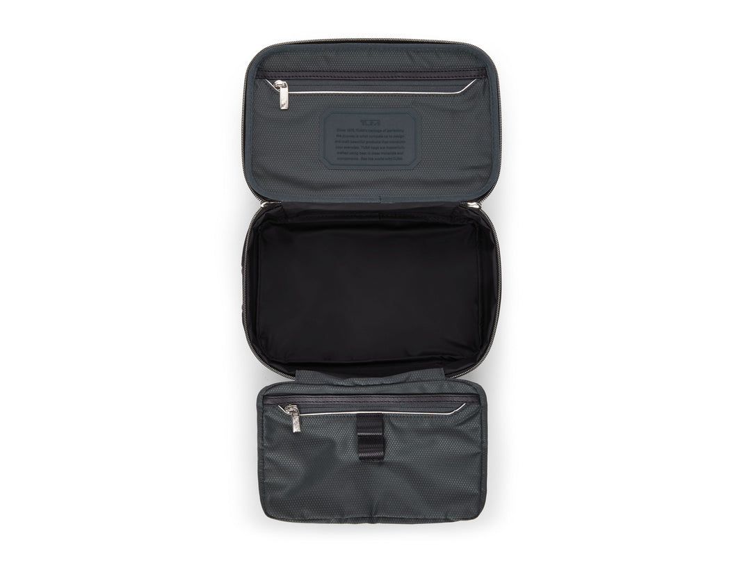 TUMI Arrivé travel kit fully open showing anti-microbial lining and organizational compartments