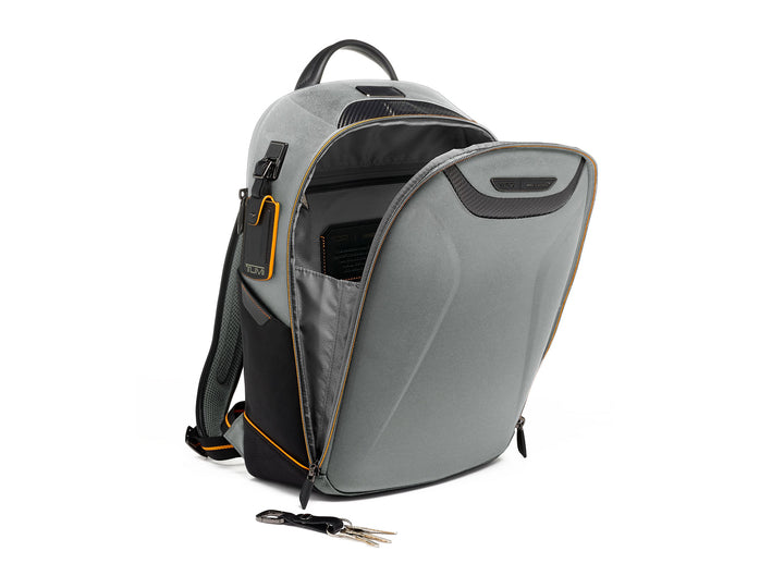 Side view of TUMI McLaren Velocity backpack showing internal compartments and key holder attachment