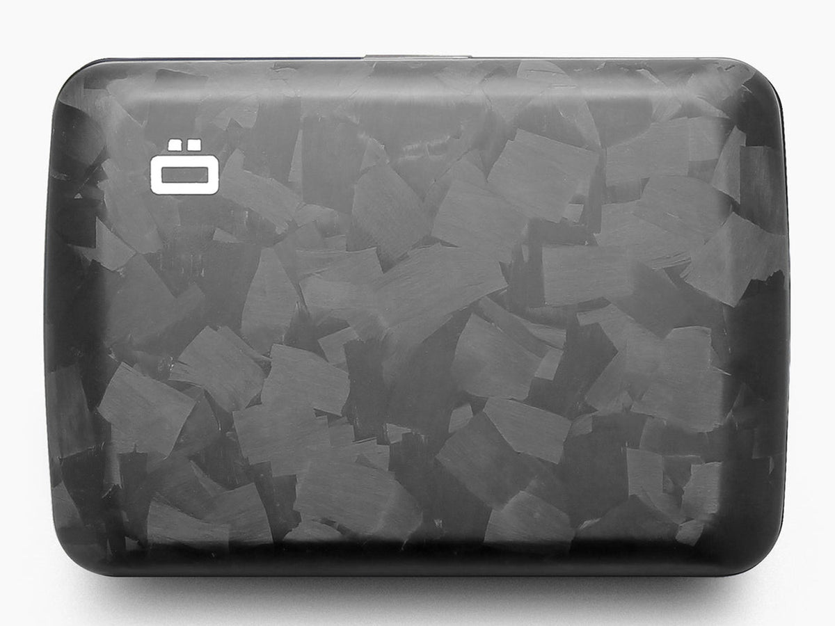 Top-down view of a forged carbon fiber wallet with matte finish and marbled pattern, featuring the Ögon logo.