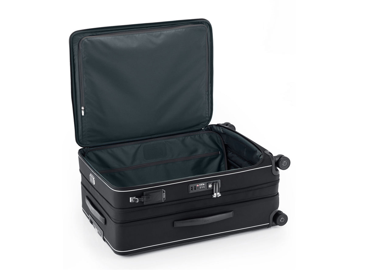 
TUMI Arrivé expandable luggage open with TSA lock and Lever Lock expansion system visible