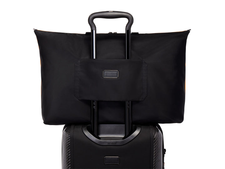 TUMI McLaren tote bag showcasing Add-a-Bag strap on luggage handle