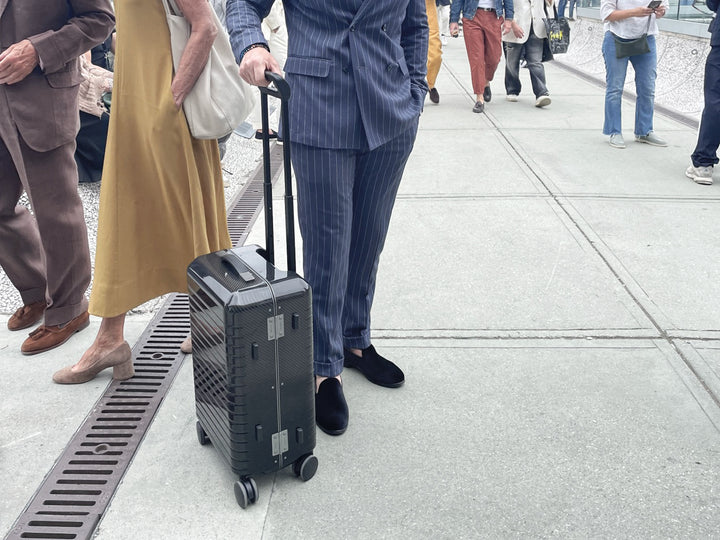 monCarbone BLACKDIAMOND Carbon Fiber Carry-On Luggage being carried around