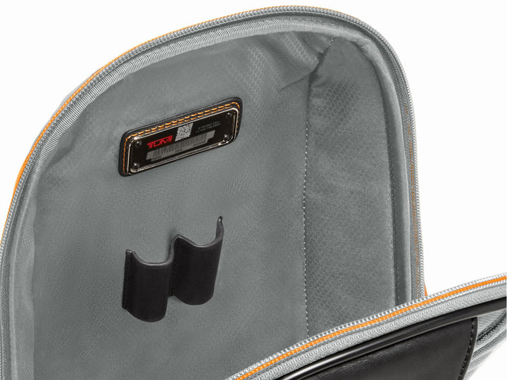 Interior detail showing TUMI Tracer tag and pen loops with Papaya orange zipper accent