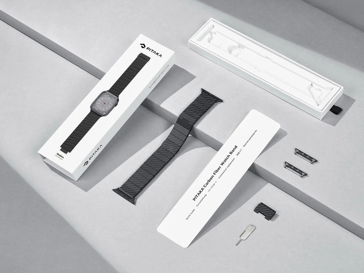 Elegant packaging of the carbon fiber watch band with components laid out, ready for assembly with an Apple Watch.