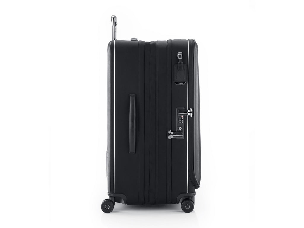 TUMI Arrivé luggage side view showing USB-C charging port, TSA lock, and Lever Lock expansion levers
