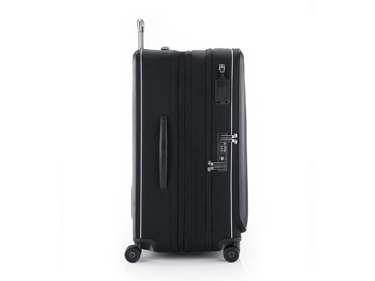 TUMI Arrivé luggage side view showing USB-C charging port, TSA lock, and Lever Lock expansion levers