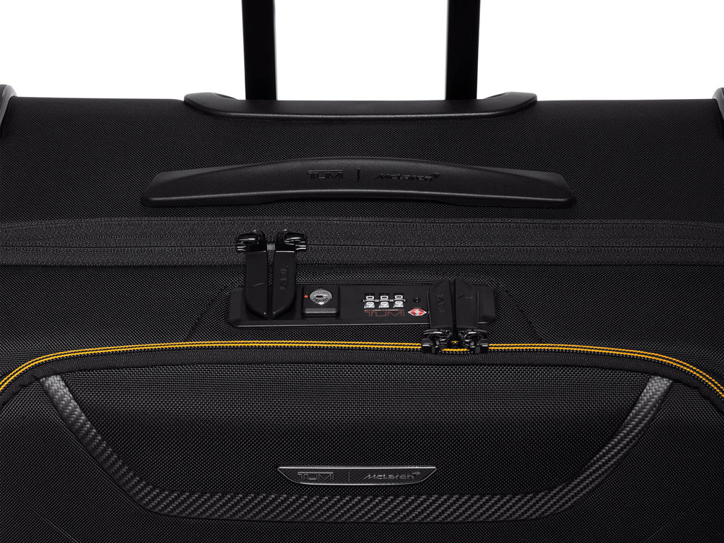 Close-up of the TUMI | McLaren Aero Extended Trip Packing Case's front pocket and carbon fiber detail.