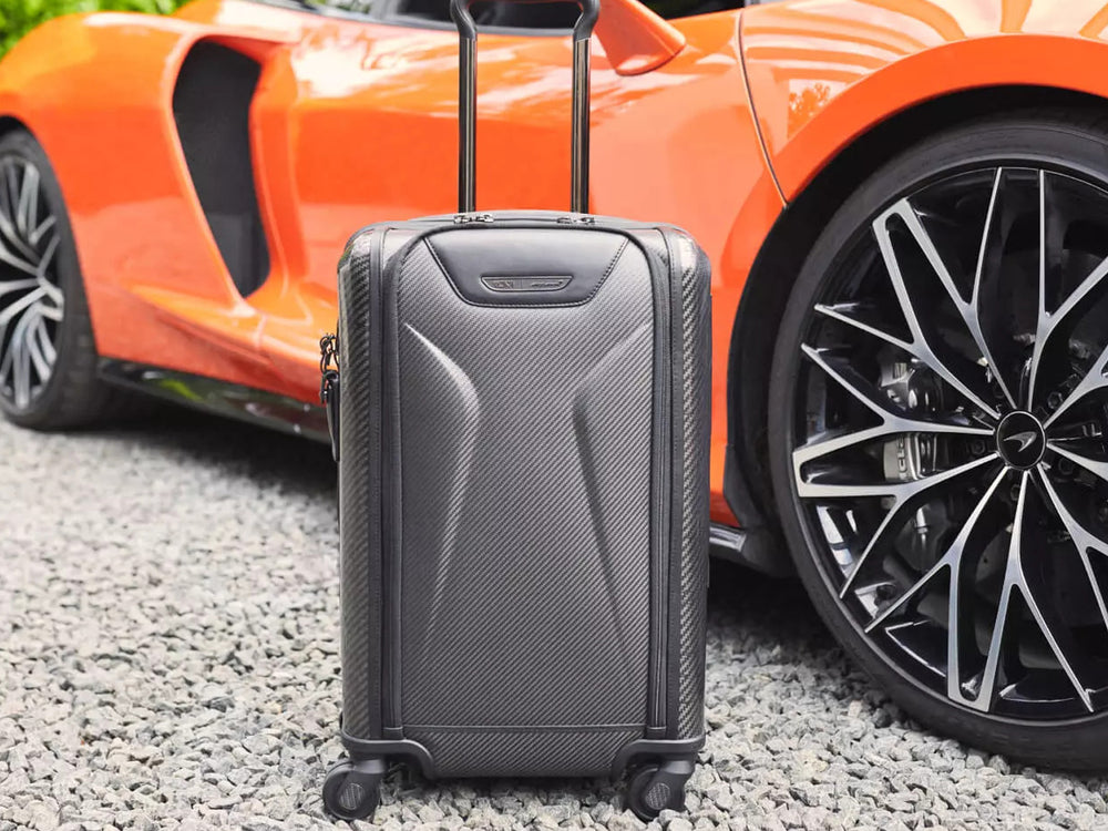 TUMI carbon fiber suitecase with McLaren in the background