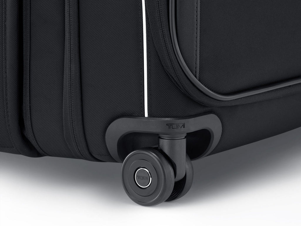Close-up of TUMI dual outboard wheel with metal ball bearings and protective shaft housing