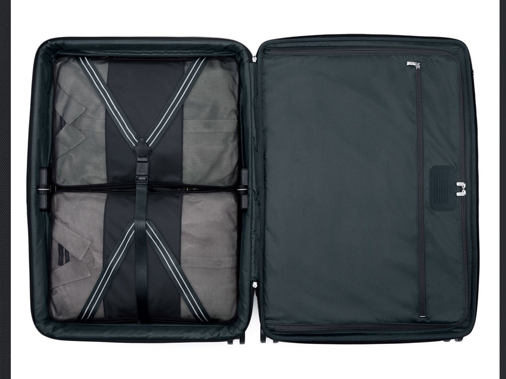TUMI Arrivé luggage interior fully packed showing compression strap system and organizational layout