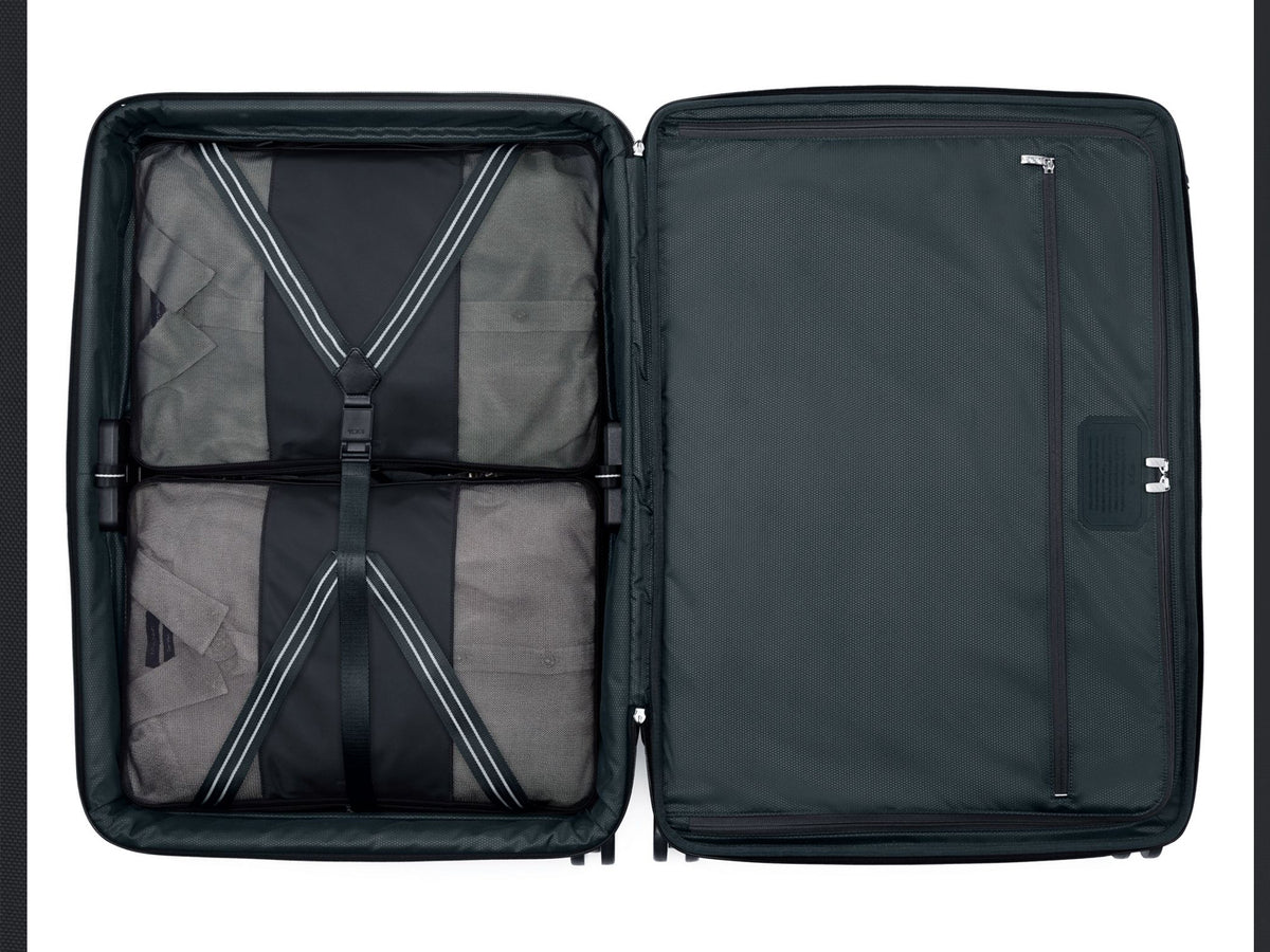TUMI Arrivé luggage interior fully packed showing compression strap system and organizational layout