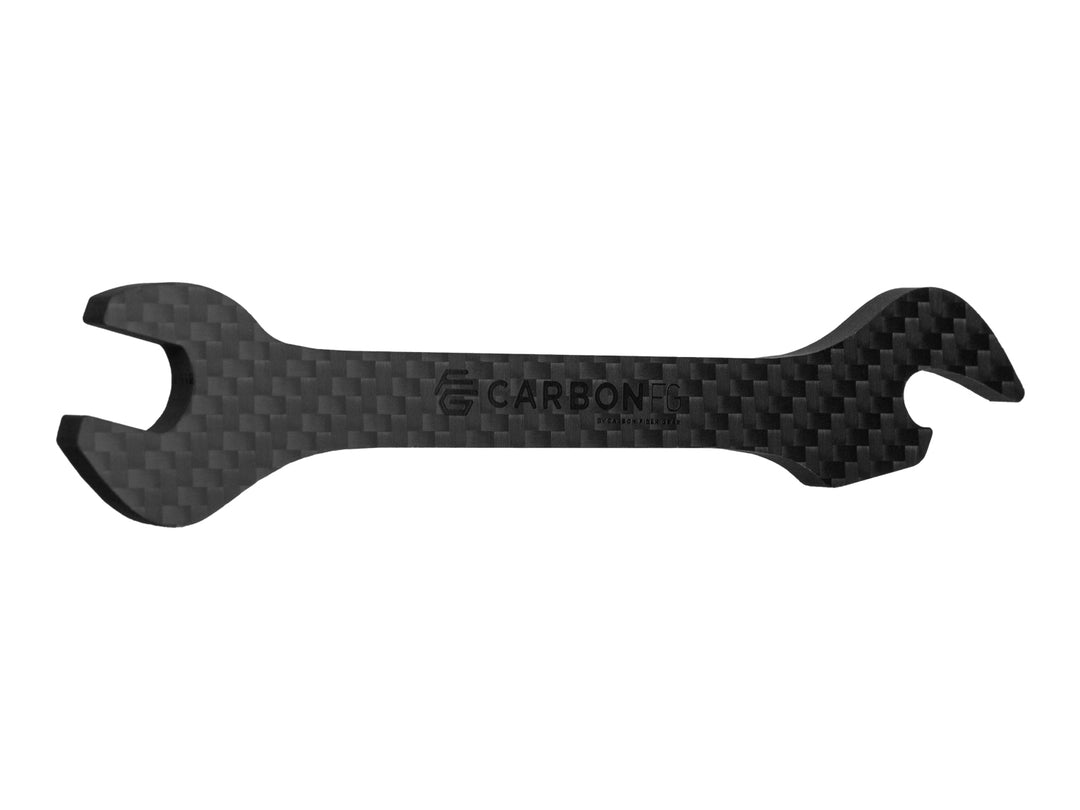 Close-up of the CarbonFG branding on the carbon fiber wrench bottle opener with a sleek twill weave finish.