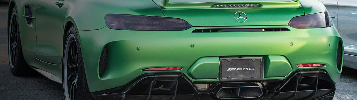 Green Mercedes AMG GT with carbon fiber license plate frame