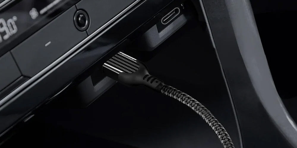 Carbon fiber USB-C cable plugged into a car dashboard USB port with braided cable detail