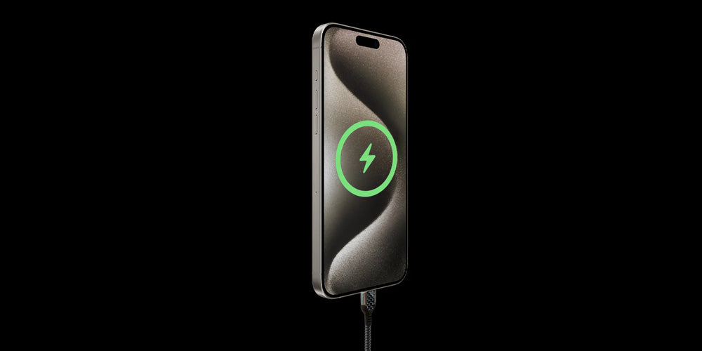 iPhone charging with carbon fiber USB-C cable, showing green power icon on black background