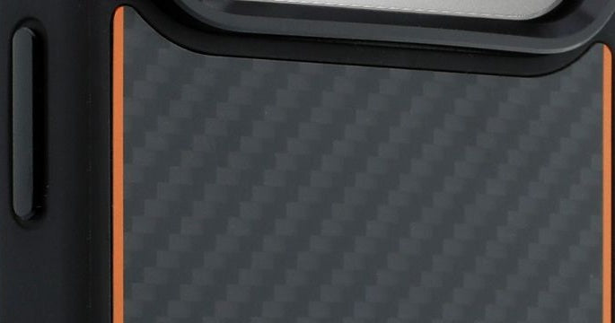 TUMI x McLaren iPhone 18 case, close view of the black bumper, metal side button and papaya line beside the matte carbon fiber