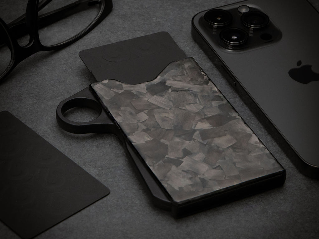 Grip6 forged carbon fiber wallet with loop on black background
