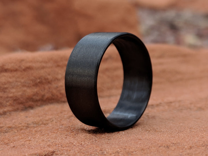 Bullet carbon fiber ring on a rock