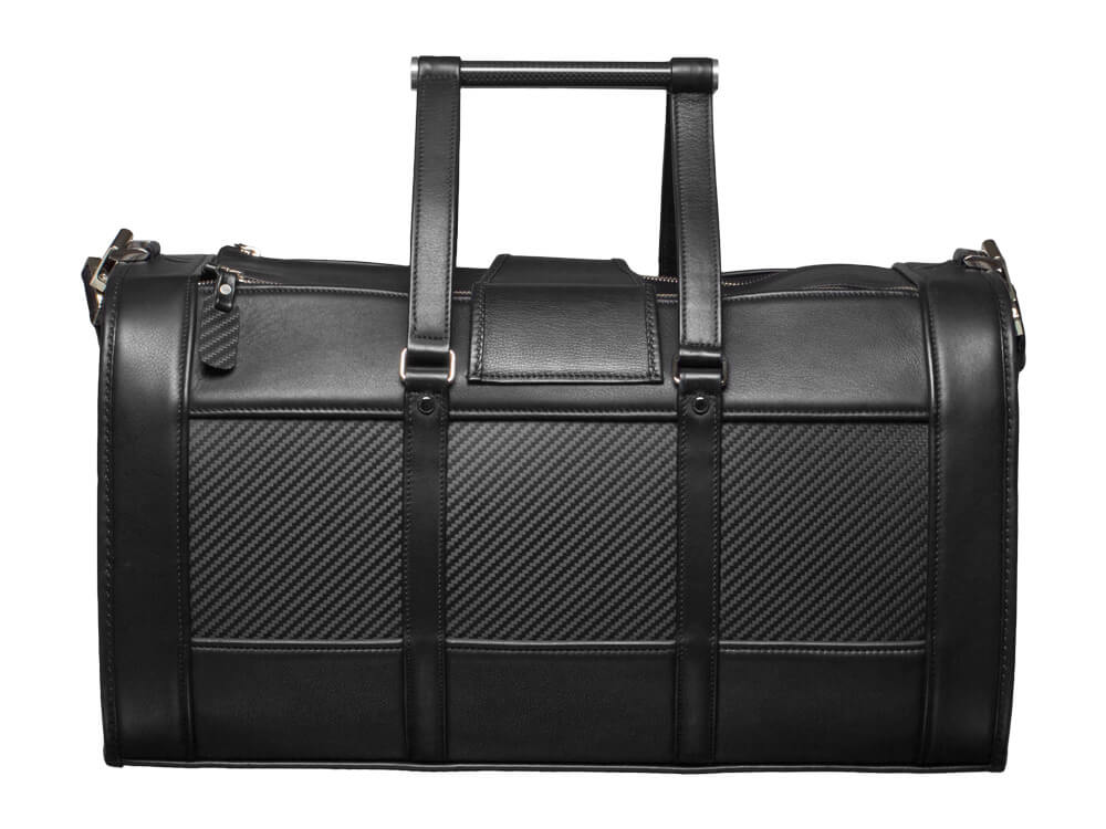 Back view of a luxurious leather weekend bag with textured carbon fiber panels.