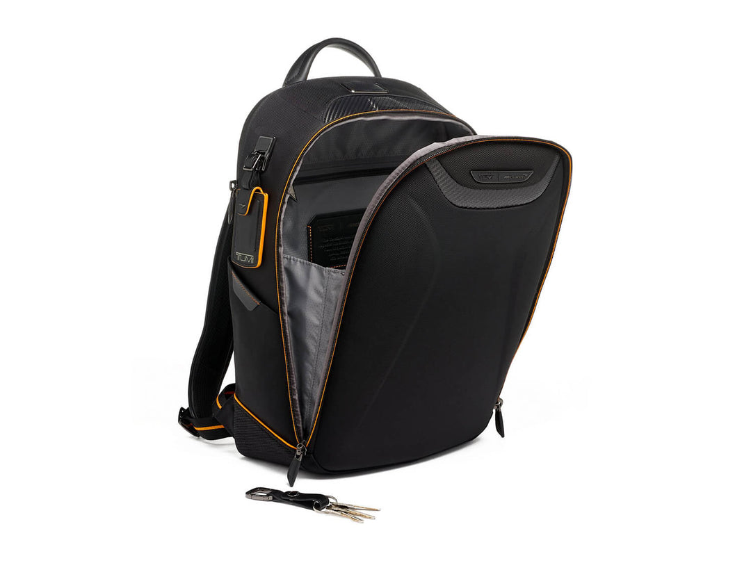 Angled view of open TUMI | McLaren Velocity Backpack revealing spacious interior and organizational pockets.