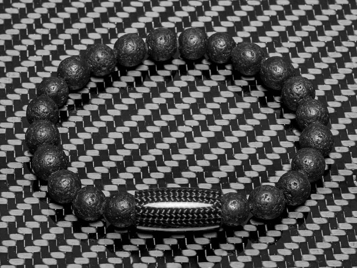 Beaded bracelet made with carbon fiber and lava rock beads on carbon fiber