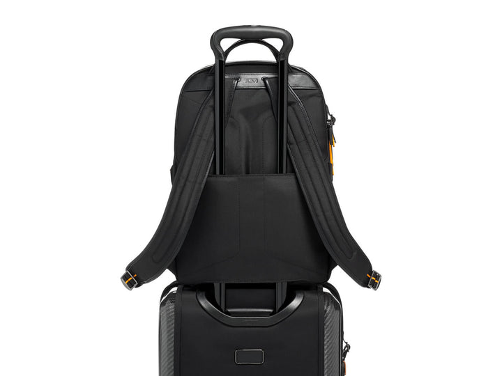 Rear strap detail of TUMI | McLaren Velocity Backpack, designed to attach to luggage handles for easy travel. Using the add a bag system.